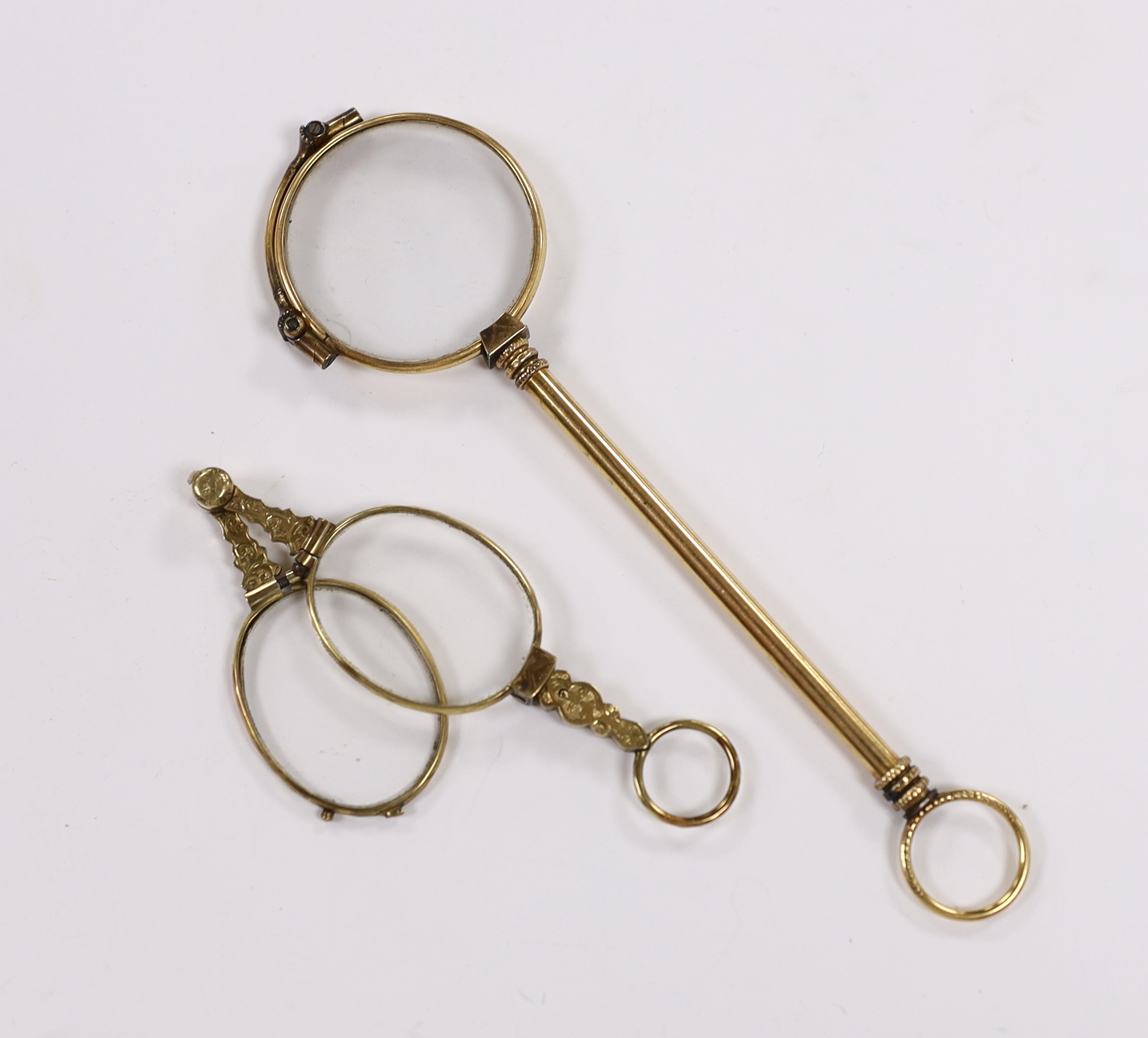 A pair of early 20th century engraved yellow metal overlaid lorgnettes, 89mm and one other large pair of lorgnettes.